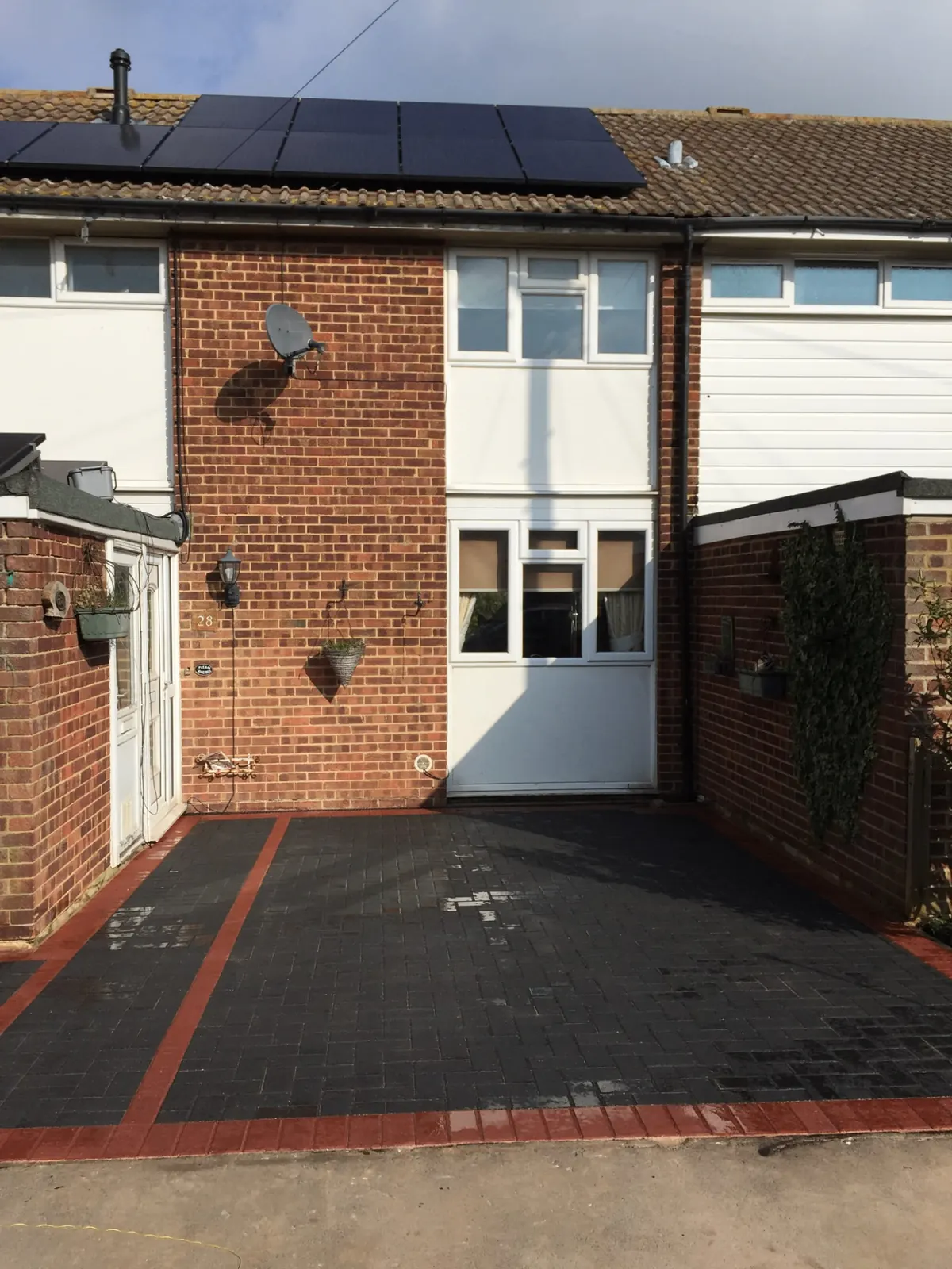 Block paving driveway with red brick border and charcoal herringbone